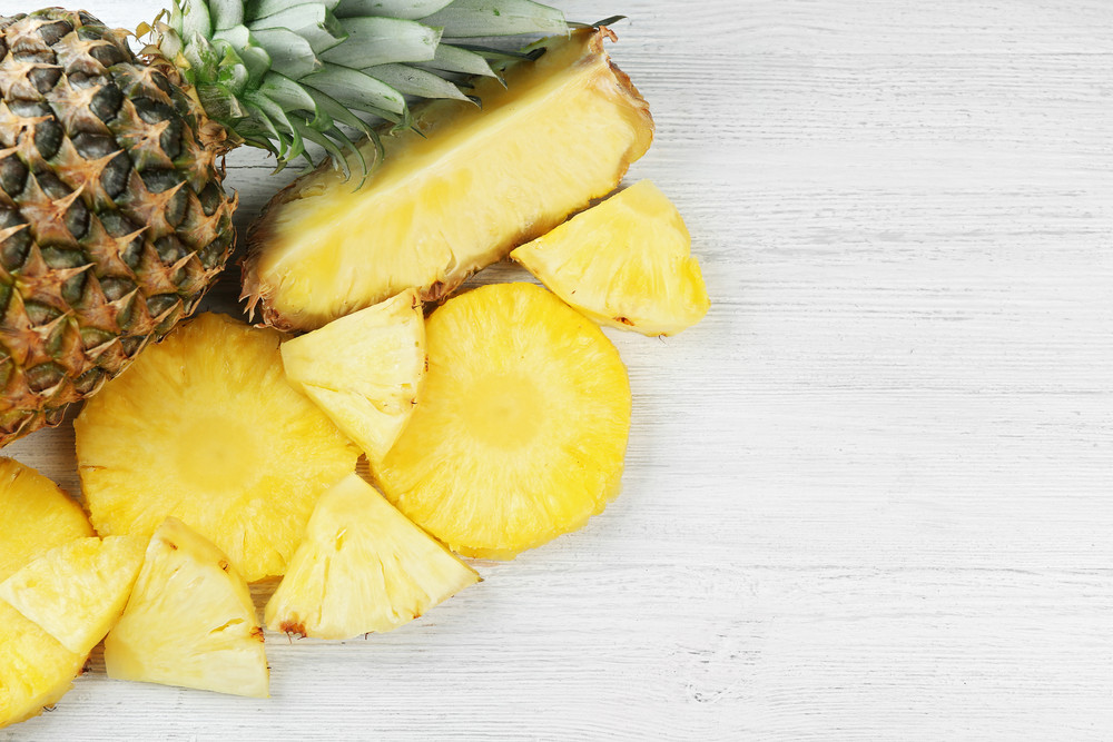 1920 stock photo cutting fresh pineapple on wooden background 399593335