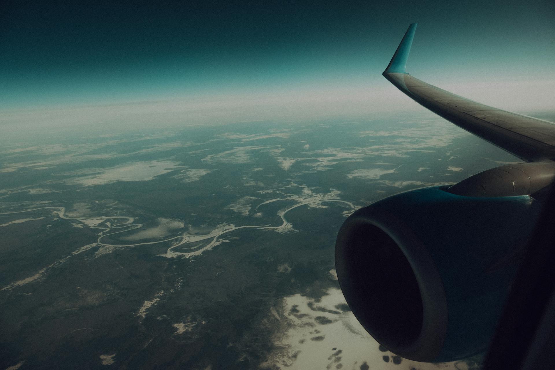 An airplane flying over land | Source: Pexels