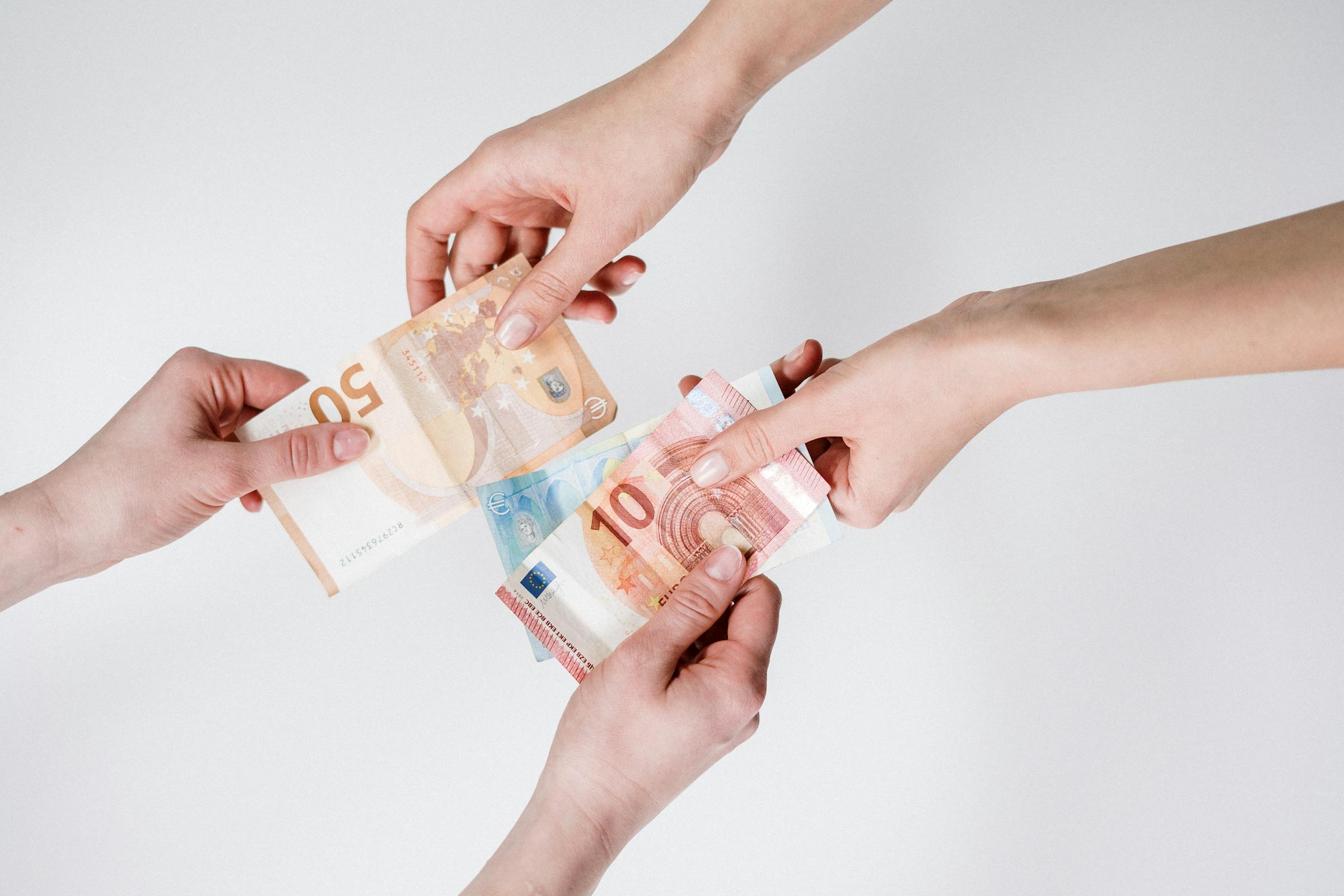 Money exchanging hands | Source: Pexels