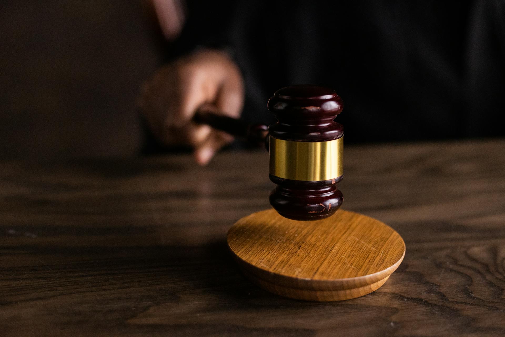 Cropped shot of a judge holding a wooden gavel | Source: Pexels