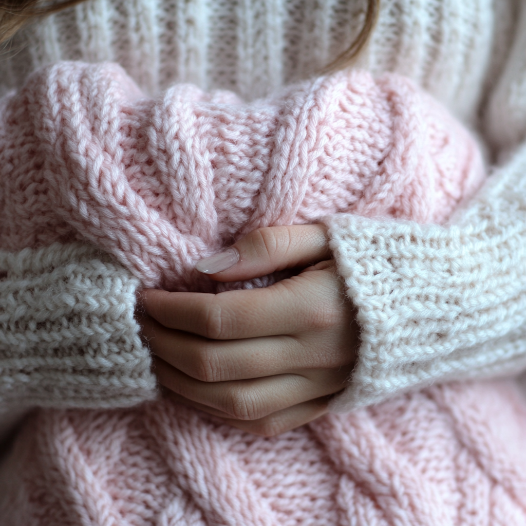 A woman holding a baby blanket | Source: Midjourney