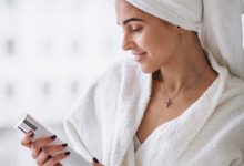 woman standing by window bathrob