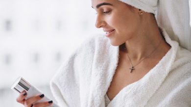 woman standing by window bathrob